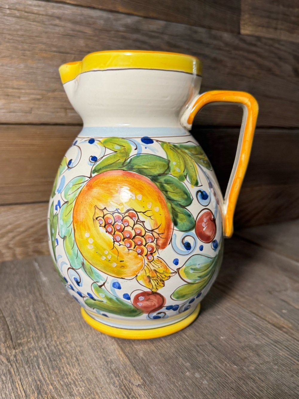 Hand-painted Italian ceramic pitcher with vibrant floral design